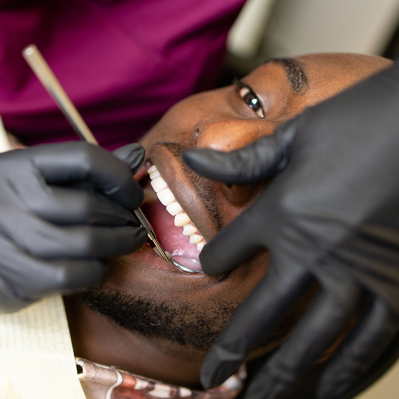 A dentist performing a detailed dental procedure